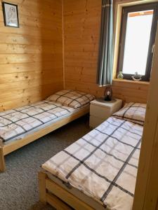 a bedroom with two beds and a window at Agroturystyka Wudarsówka in Sokolec