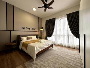 sypialnia z łóżkiem i wentylatorem sufitowym w obiekcie The Apple Premier Condo in melaka w Malakce