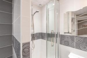 a shower with a glass door in a bathroom at L'Espiaube in Saint-Lary-Soulan