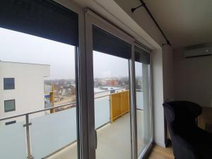 a room with a view of a balcony with windows at Premium Apartaments-Chociszewskiego 6 c in Leszno