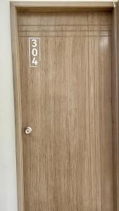 a wooden door with a sign on it at Street 55 Hotel in Bucaramanga