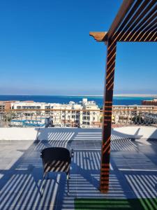 a bench on a roof with the ocean in the background at Askyhomes in Hurghada