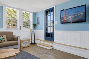 a living room with a tv on a blue wall at Gammys Beach Getaway Sleeps 20 2 blocks to Beach in Ventnor City