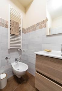 a white bathroom with a sink and a toilet at Tenuta Pascarella Bed & Breakfast in Frasso Telesino +35 photos