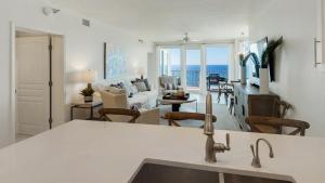 a kitchen and living room with a view of the ocean at Tranquillity 340 in Panama City Beach
