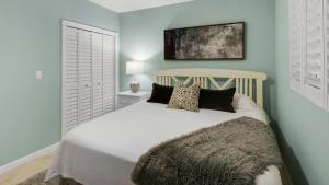 a bedroom with a large white bed with pillows at Tranquillity 340 in Panama City Beach +47 photos