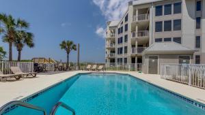 a swimming pool in front of a apartment building at Tranquillity 340 in Panama City Beach