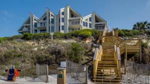 a house on a hill with stairs in front of it at Tranquillity 340 in Panama City Beach