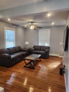 a living room with a couch and a table at Newly updated 3 bedrooms luxury house in Worcester