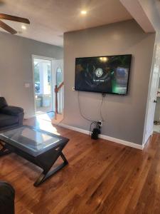 a living room with a flat screen tv on the wall at Newly updated 3 bedrooms luxury house in Worcester