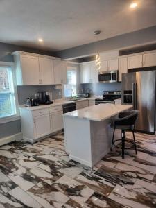 a kitchen with white cabinets and a counter top at Newly updated 3 bedrooms luxury house in Worcester