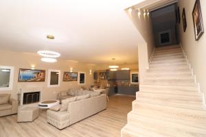 a living room with a staircase leading to a living room at Vila Mario Himare in Himare