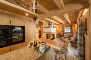 a kitchen and living room in a log cabin at Engadin Chalet - Private Spa Retreat & Appart -St Moritz - Val Bever in Bever