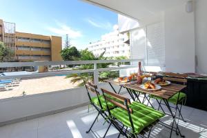 a balcony with a table with a plate of food on it at Royal Apartment Las Américas near the beach in Playa Fañabe