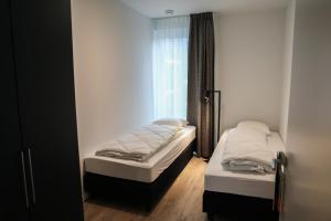 Кровать или кровати в номере Luxe loft appartement in Résidence Marina Kamperland (8 pers.)