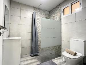 a bathroom with a shower and a toilet at Casa da Avo by Atlantic Holiday in Caniçal +30 photos