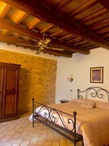 a bedroom with a bed and a ceiling fan at Residenza San Jacopo in Spello