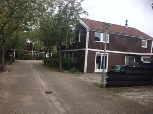 a house with a dirt road in front of it at Lovely family house nearby Amsterdam and Schiphol in Almere