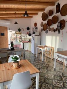 a kitchen and dining room with tables and a refrigerator at Torremana in Càbras