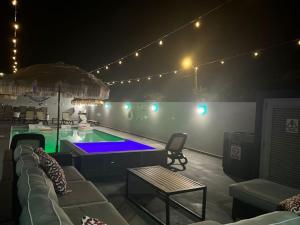 a living room with a swimming pool at night at Aquaville Dorado Moderna Villa 5 in Dorado