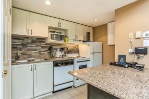 a kitchen with white appliances and a counter top at Condo 904 at North Creek Resort in Blue Mountains