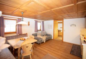 ein Wohnzimmer mit einem Tisch und einem Sofa in der Unterkunft Ferienwohnungen Wolf in Holzgau