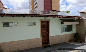 a house with a solar roof and a door at Edícula Próxima a Praias! in São Luís