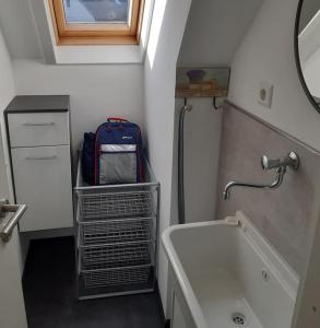 a small bathroom with a suitcase and a sink at Ferienwohnung Ganz Oben, Stadtmitte Hermeskeil in Hermeskeil