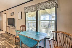 a dining room with a blue table and a window at Lakefront Wetumpka Escape with Furnished Deck! in Wetumpka