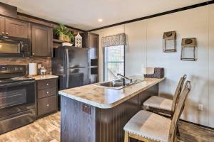 a kitchen with a sink and a refrigerator at Lakefront Wetumpka Escape with Furnished Deck! in Wetumpka