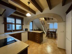 a kitchen with a table and a dining room at Villa Noray Cala Morell in Cala Morell