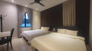 a hotel room with two beds and a window at Fairy Retreat Private Pool Cottage IPOH, BBQ, KTV, 10-12 pax in Ipoh +79 photos