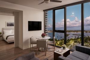a bedroom with a living room with a view of the water at AKA West Palm in West Palm Beach