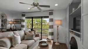 a living room with a couch and a ceiling fan at Beachwood Villas 1D in Santa Rosa Beach