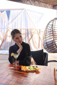 a woman sitting at a table with a plate of food at Mandalin Glamping in Selcuk +118 photos