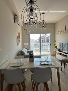 a dining room and living room with a table and chairs at Departamento moderno con vistas al rio Paraná. in Corrientes