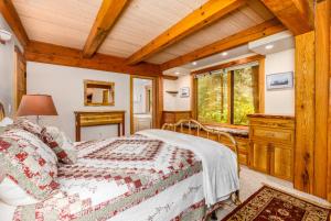 a bedroom with a bed and a wooden ceiling at Iris Pond in Girdwood
