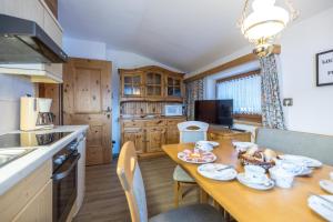 a kitchen with a table and a dining room at Haus Carmen in Stumm