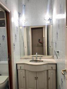 a bathroom with a sink and a mirror at Hotel Bonino in Villa Mercedes