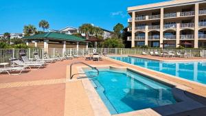 a swimming pool with chairs and a hotel at Sea Haunts 1A in Santa Rosa Beach