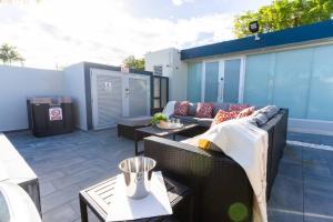 a patio with a couch and a table at Aquaville Dorado Moderna Villa 1 in Dorado