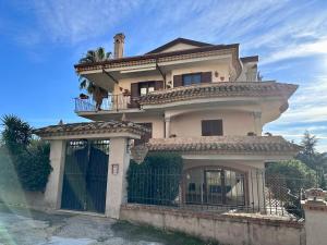 a large house with a fence in front of it at Piccola Dimora Villa Candido in Stilo