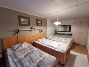 Cette chambre comprend 2 lits et un miroir. dans l'établissement Vuotson Maja B&B, à Vuotso
