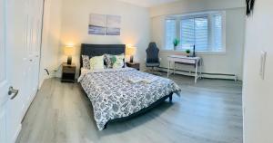 a bedroom with a bed and a desk and a window at 3 Bedroom Art Home - 8 Minutes to Downtown Vancouver in Vancouver