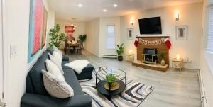 a living room with a couch and a fireplace at 3 Bedroom Art Home - 8 Minutes to Downtown Vancouver in Vancouver