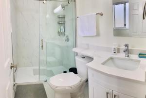 a bathroom with a shower and a toilet and a sink at 3 Bedroom Art Home - 8 Minutes to Downtown Vancouver in Vancouver