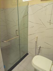 a bathroom with a glass shower with a toilet at Canal view hotel in Faisalabad