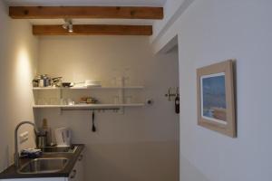a kitchen with a sink and a counter top at Hotel Steeds aan Zee in Katwijk