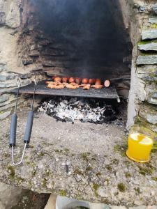 a grill with a bunch of hot dogs on it at agroturystyka Pensjonat PAULA in Muszyna