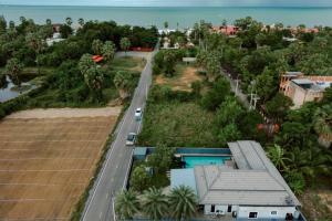 an aerial view of a road next to a house at Onyx Stay Pool Villa @Pranburi in Ban Nong Sua